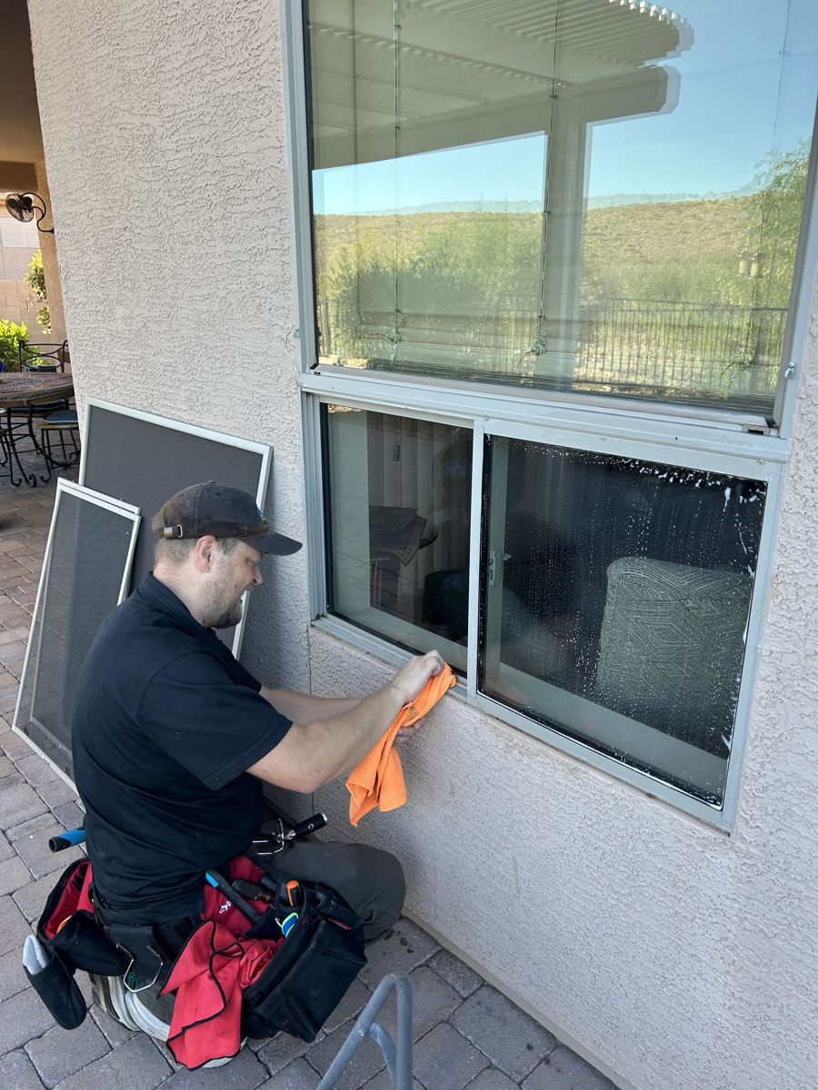 Carl wiping down a window track and sill by hand